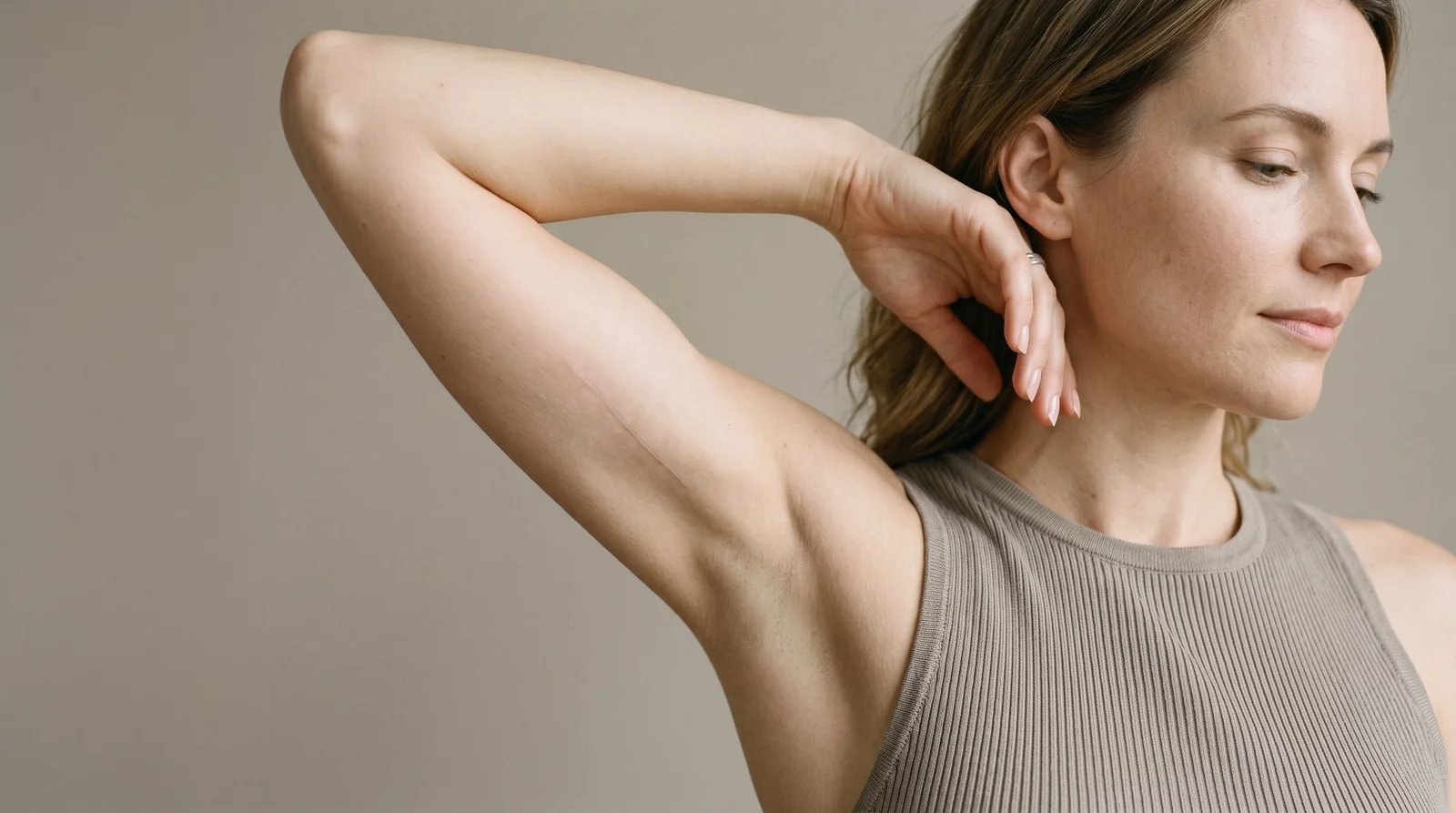 The arm lift scar sits on the inner upper arm, where clothing conceals it